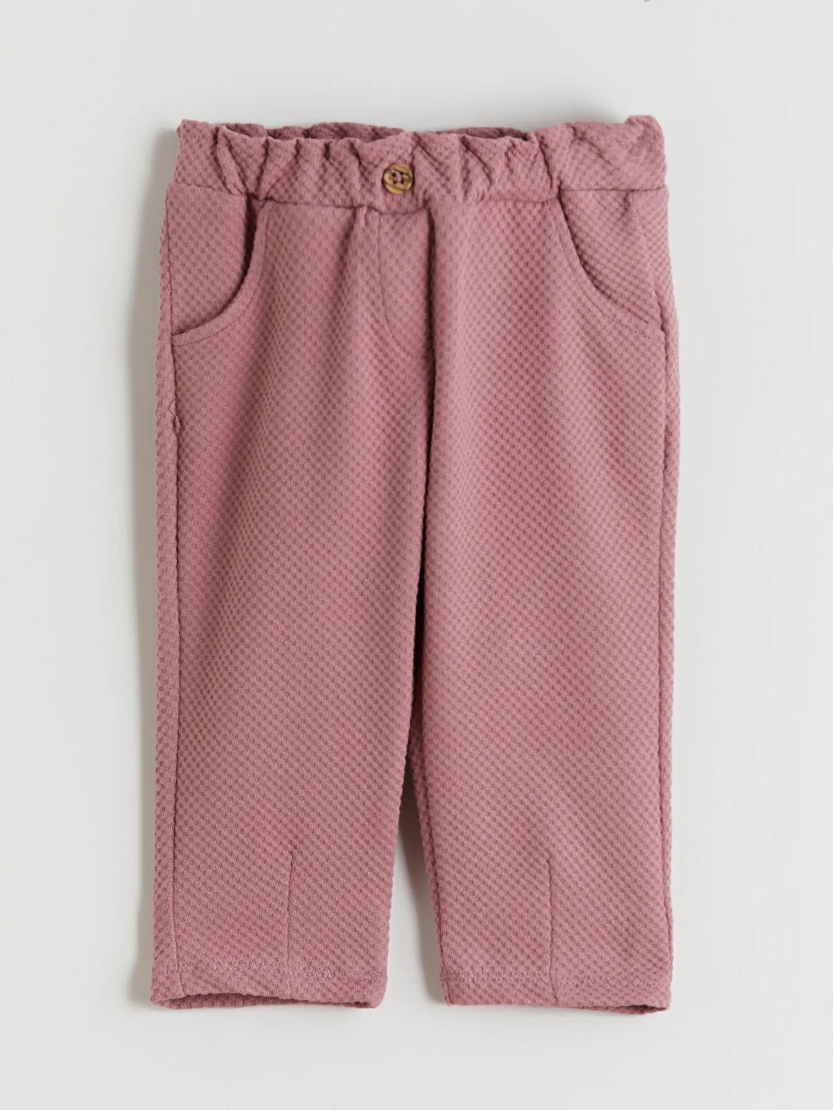 Off-white Peter Pan collar girl's blouse and trousers.